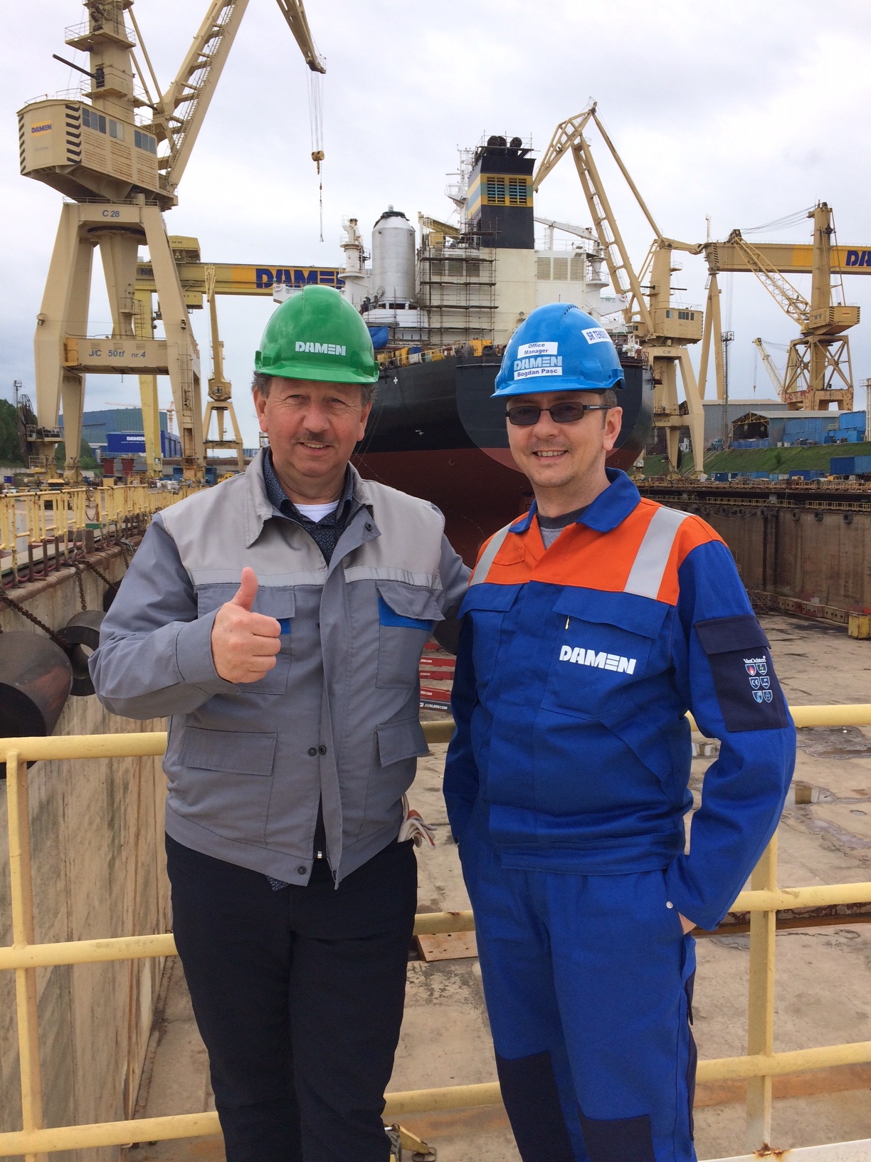 Area Manager for Greece, of DAMEN Shiprepair & Conversion, Mr. Carlos de Vliegere (on the left) and Sales Manager of DAMEN Shipyards Mangalia, Mr. Bogdan Pasc (on the right) visiting the Dock where M/V  AGRARI  - first of the 10  vessels of TMS TANKERS’ Project at DAMEN Shipyards Mangalia is under DD repairs, Scrubber and BWTS Installation. April – May 2019.